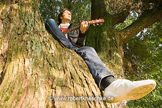 Im Baum Gitarre spielen